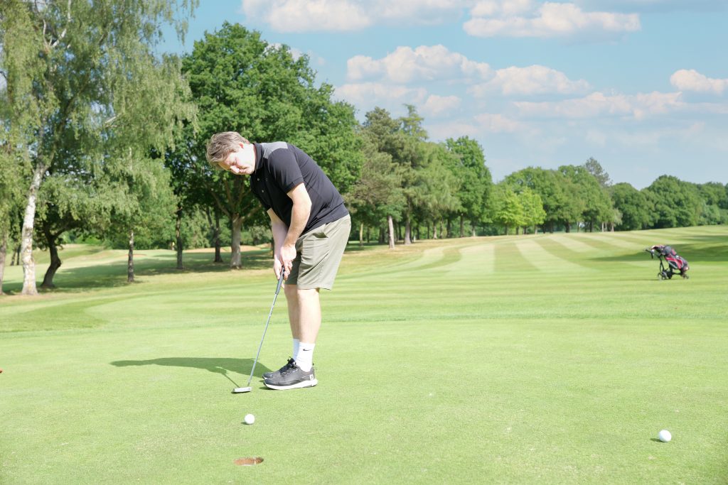Golfer putting on the green during the 41st Annual CWRF Charity Golf Day at Moor Park Golf Club, supporting children’s charities across the UK.